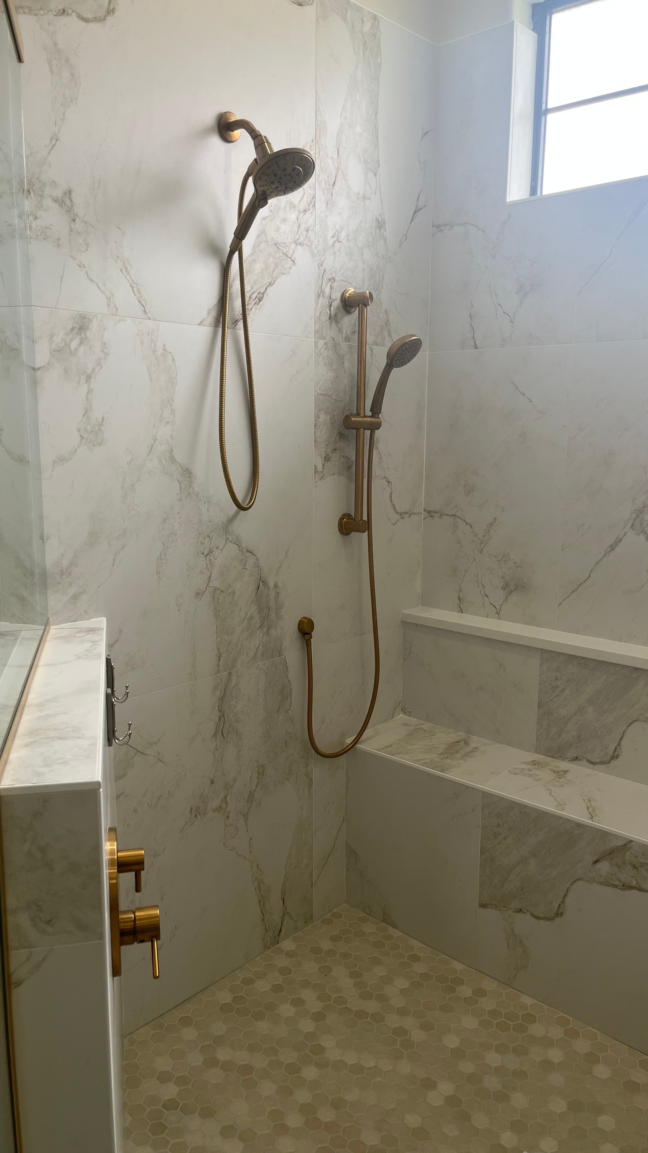 Spa-style shower with rainfall head and custom tile accent wall